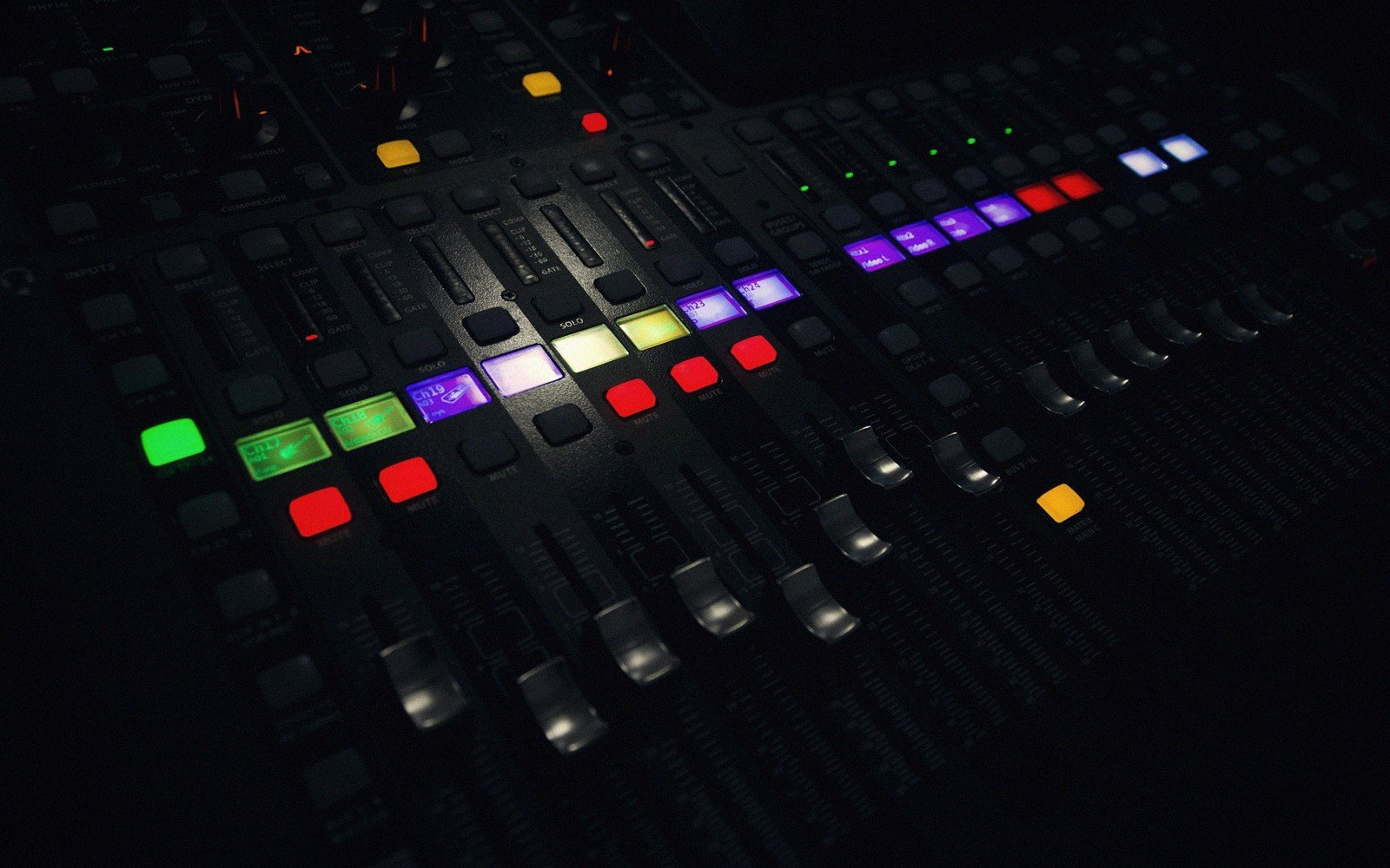 A mixing desk under low studio light