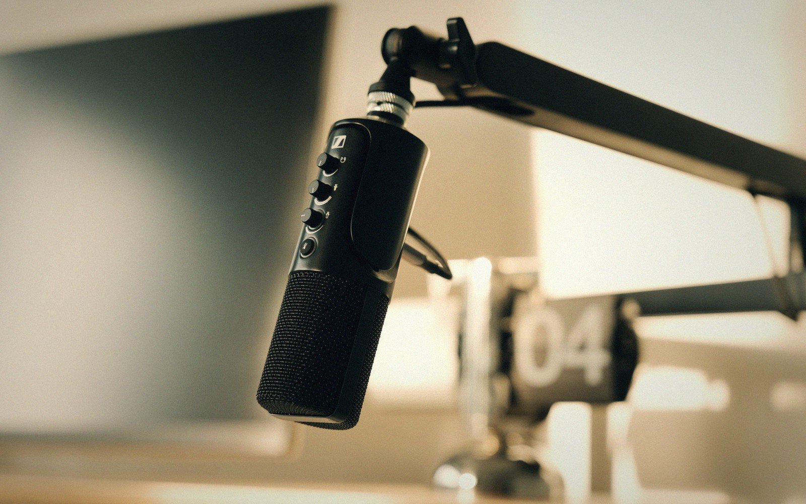 a broadcast microphone on a boom arm, close up